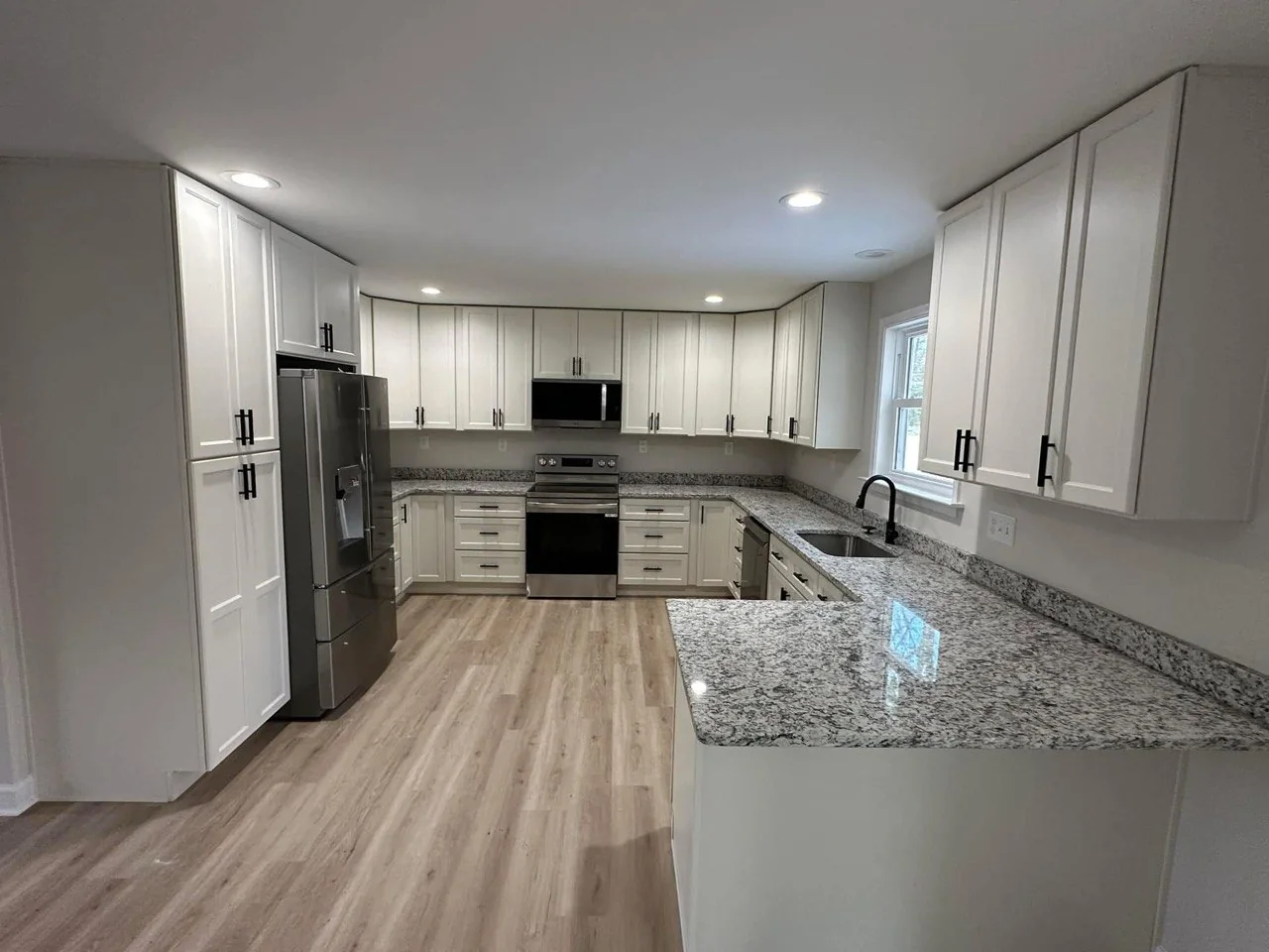 Completed white kitchen with dark counters