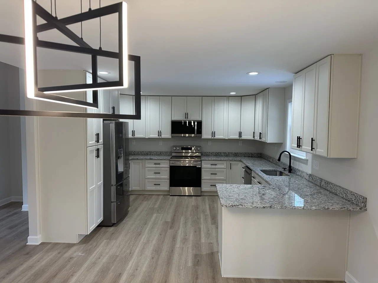 White kitchen cabinetry with peninsula