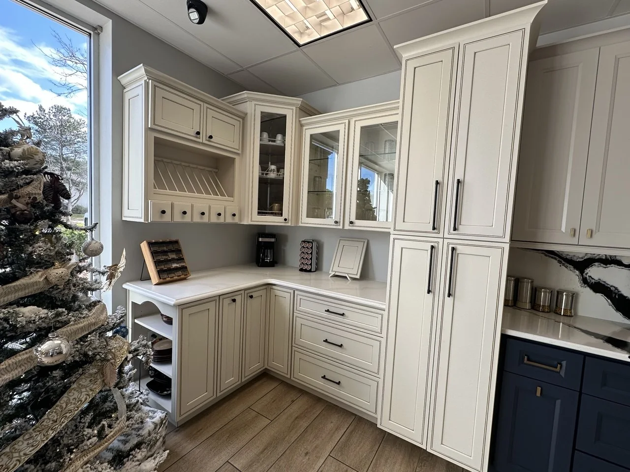 Custom built-in cabinetry with glass doors and navy lower cabinets