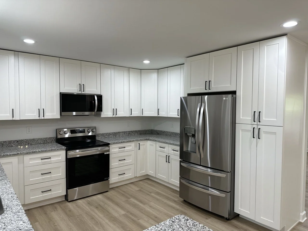 Completed white kitchen with full-height cabinetry
